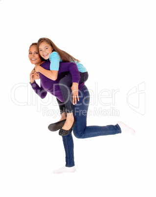 Mother piggyback her daughter.