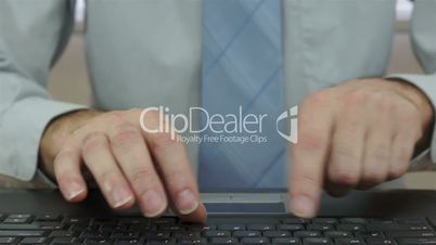 Businessman Slamming Laptop Keyboard