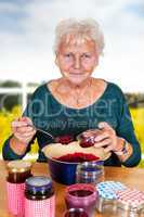 Senior woman filling homemade jam in the glass
