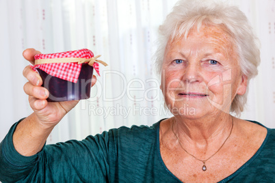 Grandma holds up her homemade jam