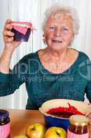 Grandma holds up her homemade jam