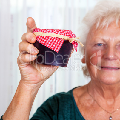 Grandma holds up her homemade jam