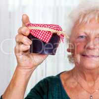 Grandma holds up her homemade jam