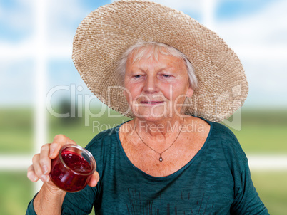 One Mature woman with straw hat and homemade jam