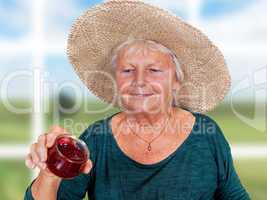 One Mature woman with straw hat and homemade jam