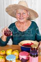 One Mature woman with straw hat and homemade jam