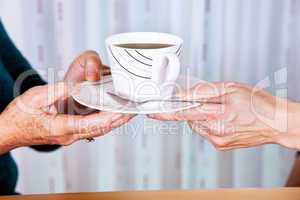 Hands holding cup