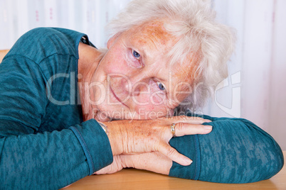 Portrait, woman lays head on hands