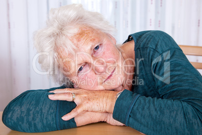 Portrait, woman lays head on hands