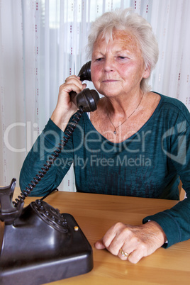 Phoning woman with old analog phone while