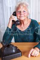 Phoning woman with old analog phone while