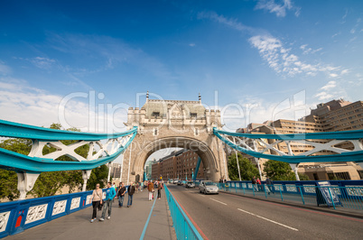 LONDON - AUG 28: Tourists walk along Tower Bridge in the United