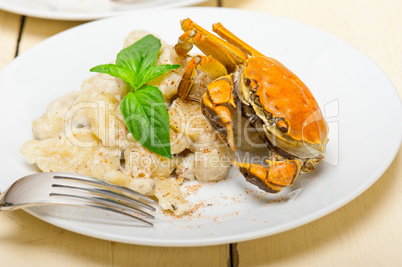 Italian gnocchi with seafood sauce with crab and basil