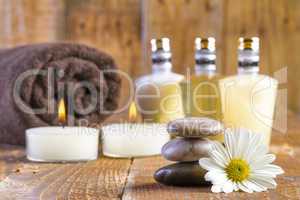 zen basalt stones and spa oil with candles on the wood