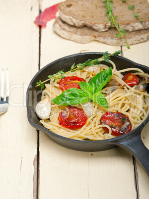 spaghetti pasta with baked cherry tomatoes and basil