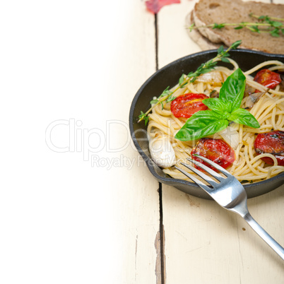 spaghetti pasta with baked cherry tomatoes and basil