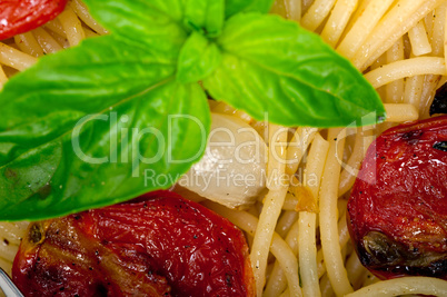 spaghetti pasta with baked cherry tomatoes and basil