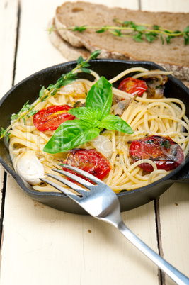 spaghetti pasta with baked cherry tomatoes and basil