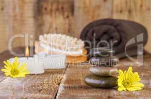 zen basalt stones and spa oil with candles on the wood