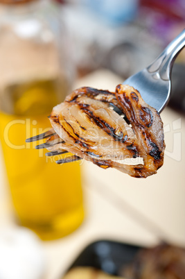 grilled onion on a fork