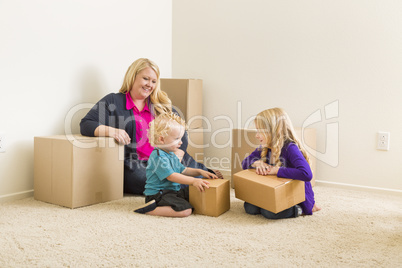 Young Family In Empty Room with Moving Boxes