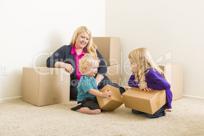 Young Family In Empty Room with Moving Boxes