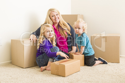 Young Family In Empty Room with Moving Boxes