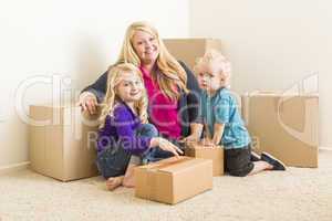 Young Family In Empty Room with Moving Boxes