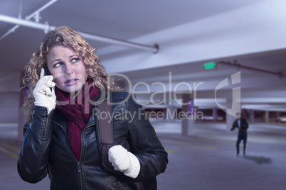 Frightened Young Woman On Cell Phone in Parking Structure