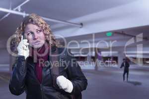 Frightened Young Woman On Cell Phone in Parking Structure