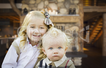Cute Brother and Sister Pose In Rustic Cabin