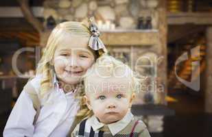 Cute Brother and Sister Pose In Rustic Cabin