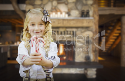 Cute Young Girl Holding Candy Canes in Rustic Cabin