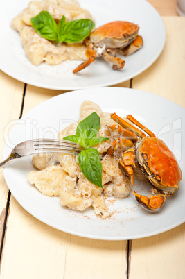 Italian gnocchi with seafood sauce with crab and basil