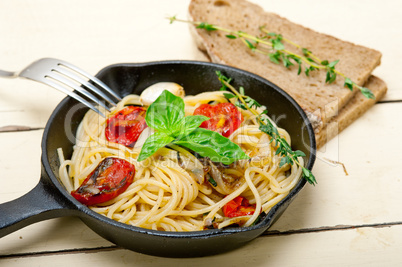 spaghetti pasta with baked cherry tomatoes and basil