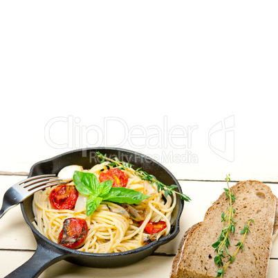 spaghetti pasta with baked cherry tomatoes and basil