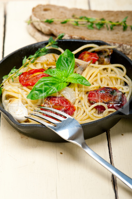 spaghetti pasta with baked cherry tomatoes and basil