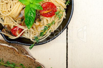 spaghetti pasta with baked cherry tomatoes and basil