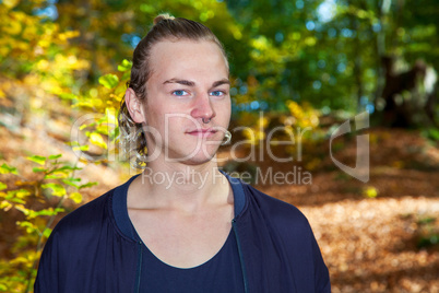 Portrait of a young man in autumn park