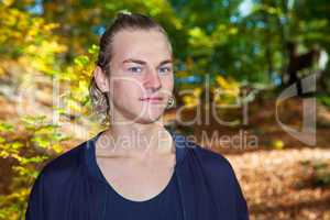 Portrait of a young man in autumn park