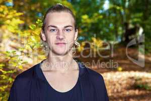 Portrait of a young man in autumn park