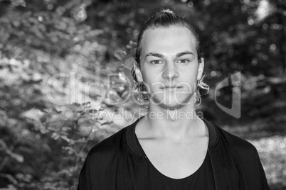 Portrait of a young man in autumn park