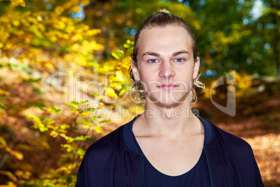 Portrait of a young man in autumn park