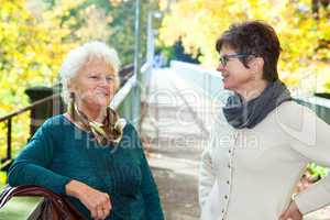 Two women in autumnal park