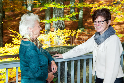 Two women in autumnal park