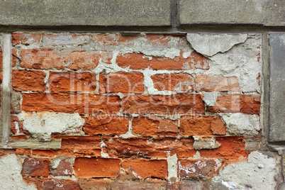 Old brick wall with plaster shelled