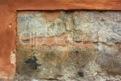 Old stone wall with plaster shelled