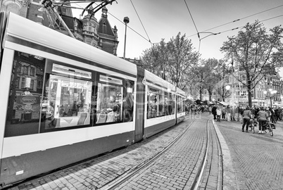 AMSTERDAM - APR 30: Tram running in the city centre amongst pede