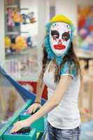 Girl in a mask of a clown at children's parties