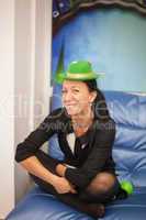 Young woman in a green cap on birthday